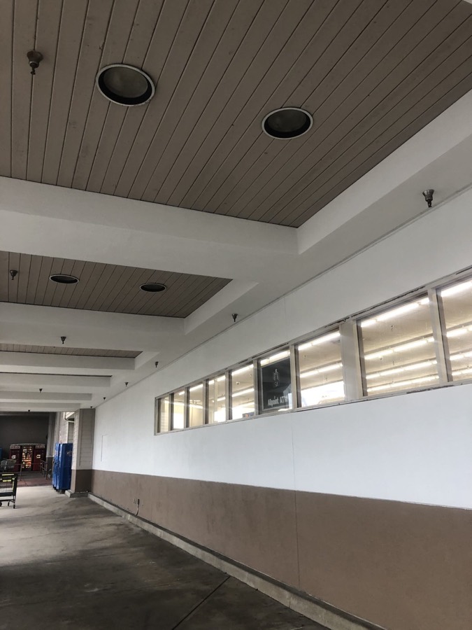 Commercial interior corridor with painted walls and ceiling