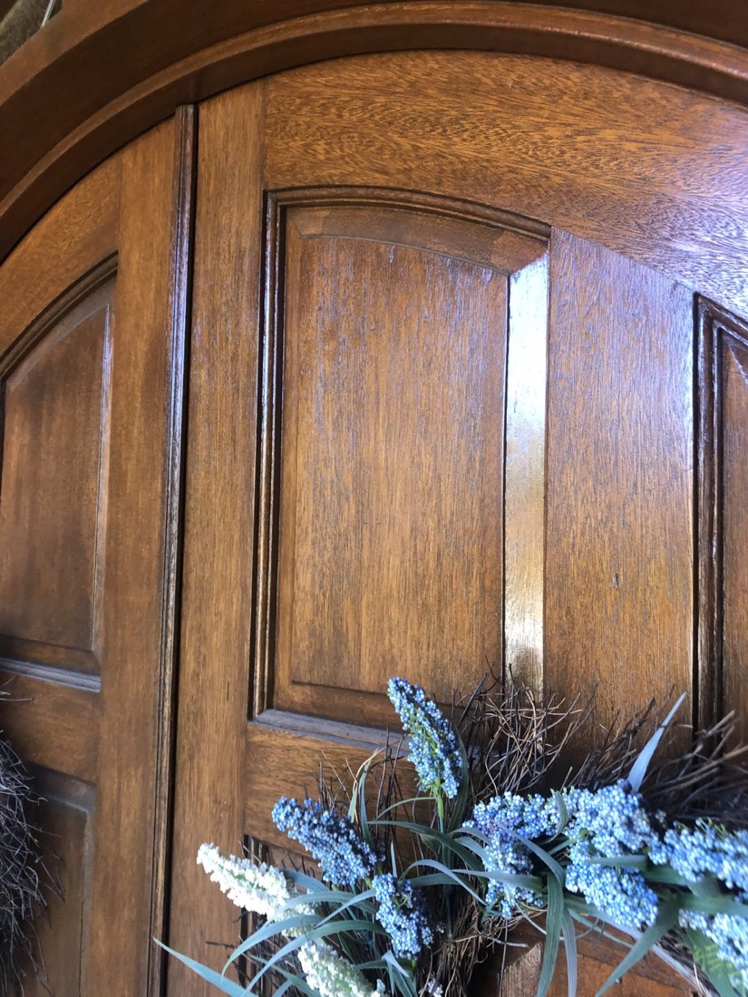 Wood door being refinished with custom stain